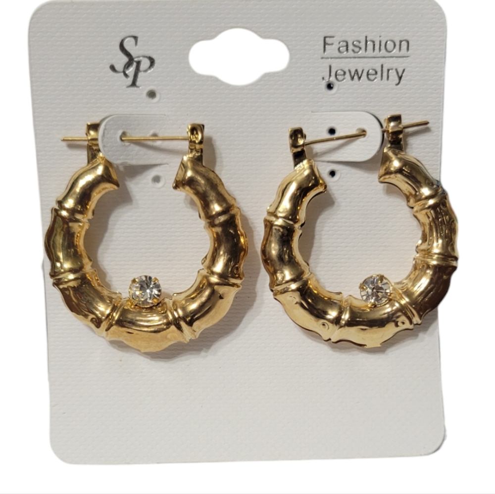 ornate gold colored hoops with rhinestone in the center